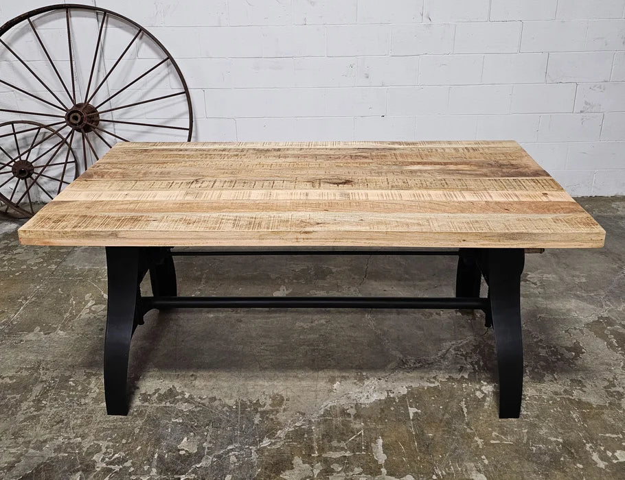 Crank dining table with matt black steel base and natural mango wood top